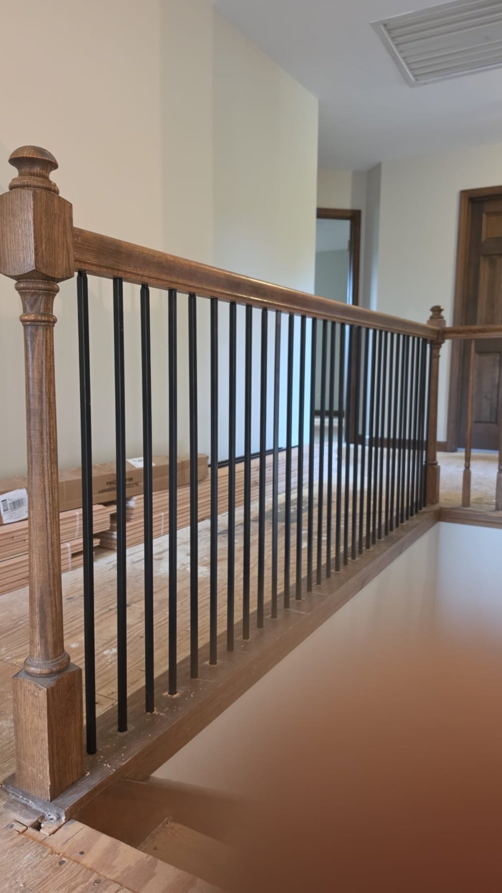 Stairs & Balustrade project by Goodman Painters in Oak handrail, iron balusters