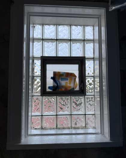 Bathroom glass-block window and sill after prep and glossy enamel repaint in Chicago